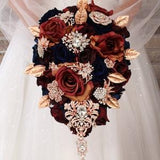 Dark wedding bouquet. Navy blue and burgundy bridal bouquet. Rose gold brooch bouquet. Jeweled cascade bouquet.