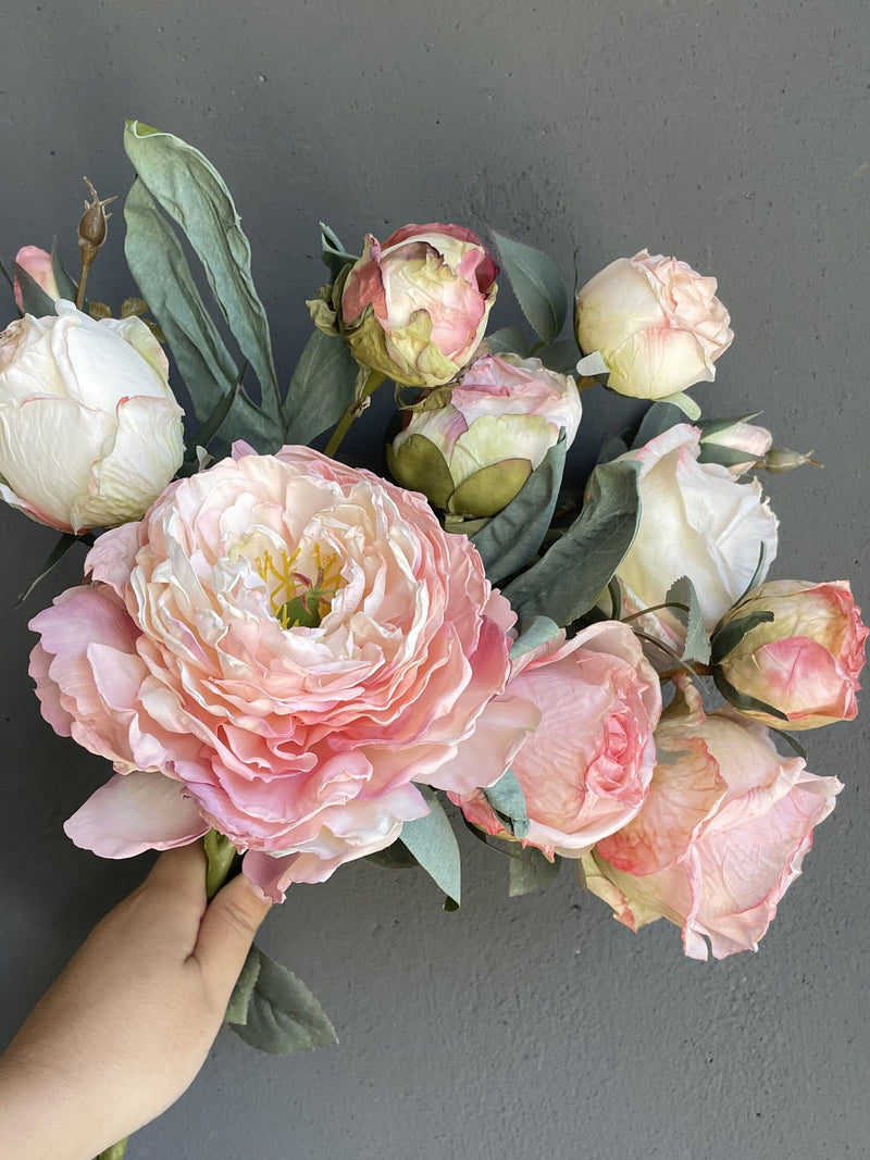 Artificial dried-look peony and rose bouquet with pale pink blooms and green leaves
