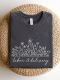 Dark gray labor & delivery T-shirt with white floral line art across chest