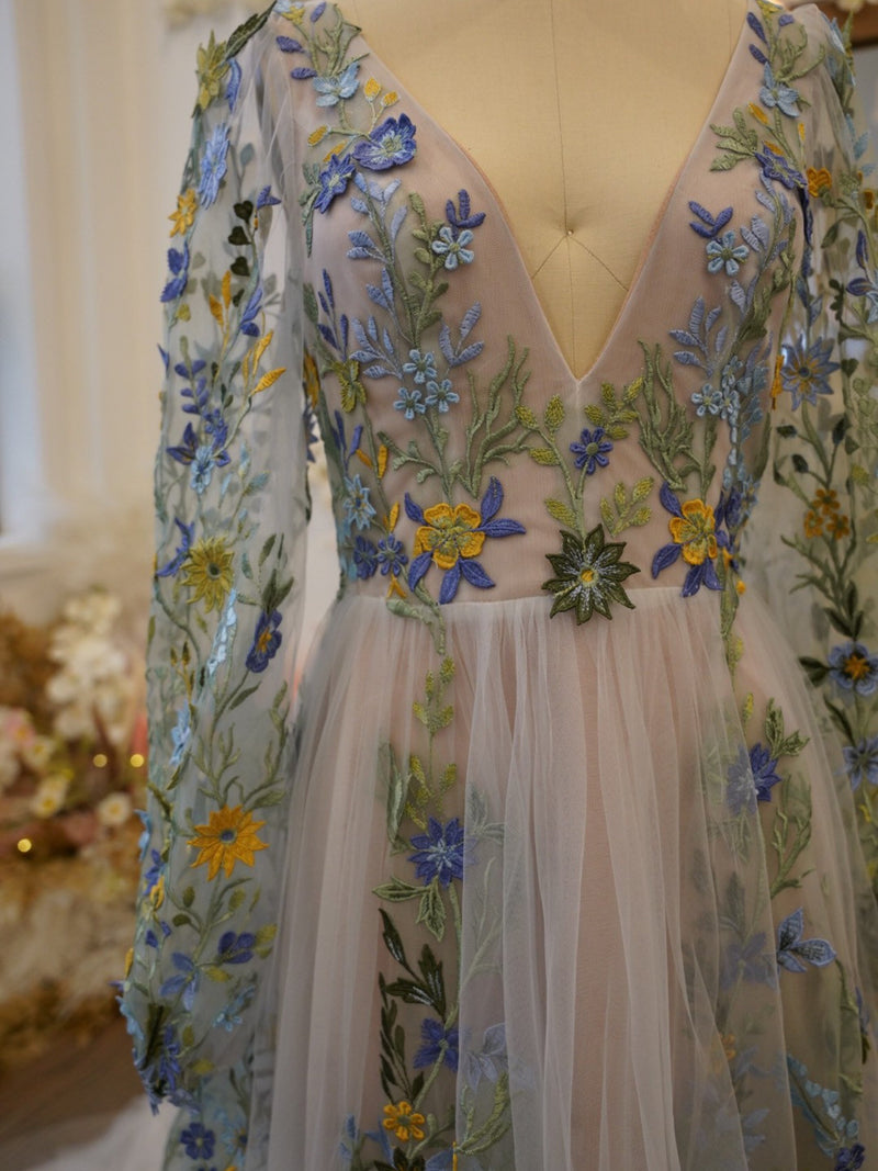 Floral embroidered wedding dress with deep V neckline, sheer long sleeves, tulle skirt