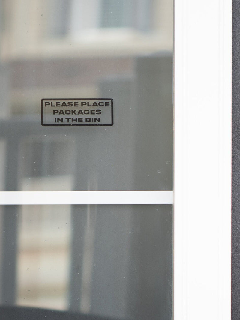 Window vinyl decal sign: “Please Place Packages in the Bin”