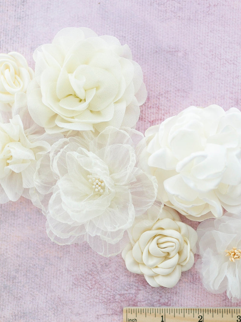 Ivory fabric millinery flower set with seven cream flowers, different sizes