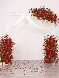 Red rose floral wedding arch decor with draped white fabric and glass vase pieces