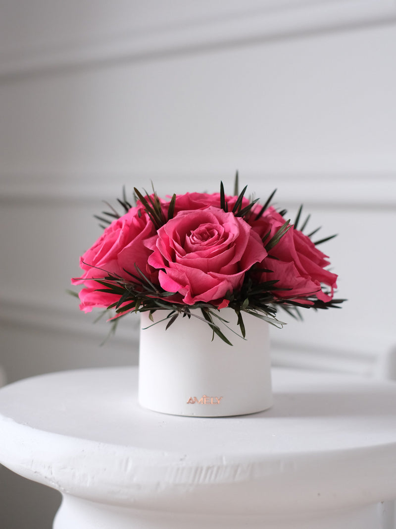 Mini preserved bouquet with pink roses in a white concrete vase
