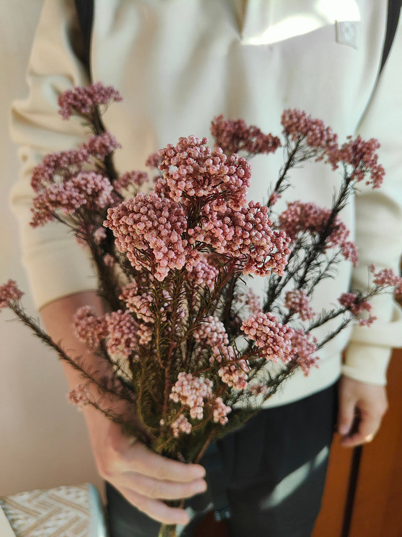 Pink preserved rice flower bunch with dried stems, tied bouquet