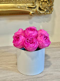 Pink preserved peonies in a white round box arrangement