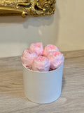 White gift box filled with pink preserved peony blooms
