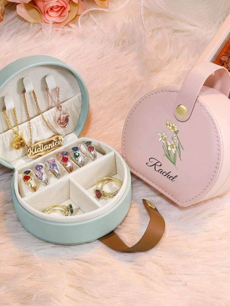 Round mint travel jewelry box with open compartments, pink engraved floral name tag