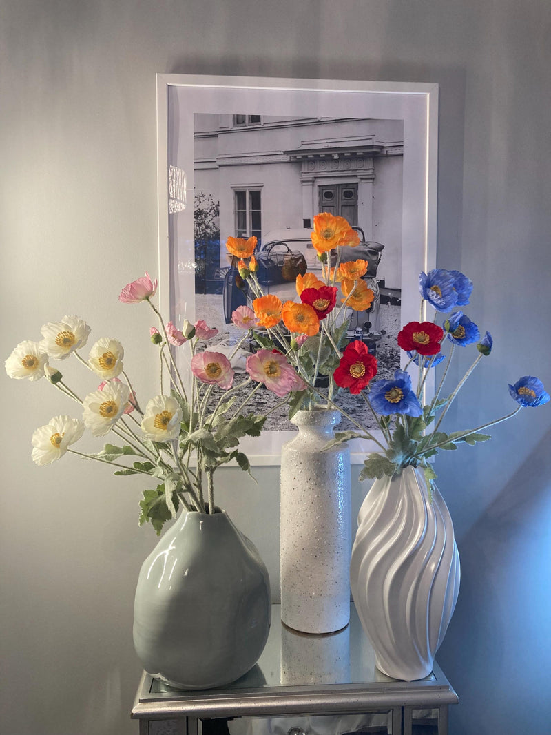 Silk flower stems with multiple blooms in two vases, orange blue pink and red