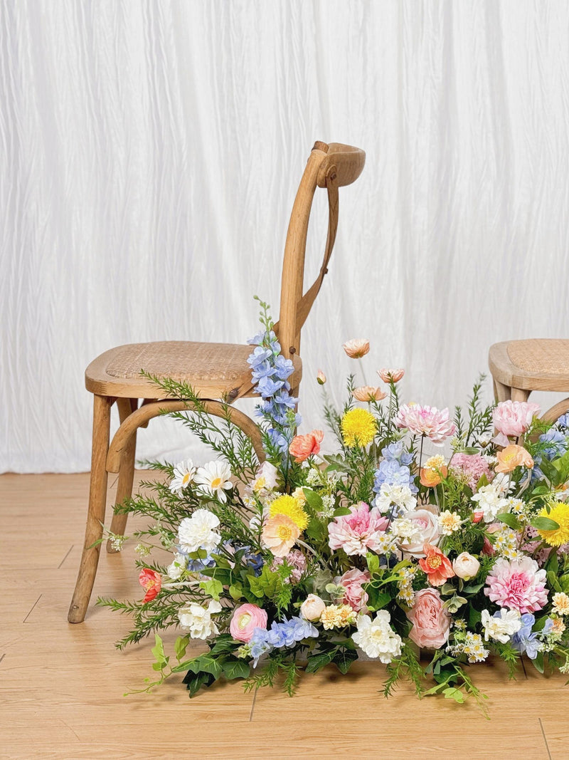 Pastel wildflower floor bouquet with mixed pink, blue, yellow, white blooms and greenery