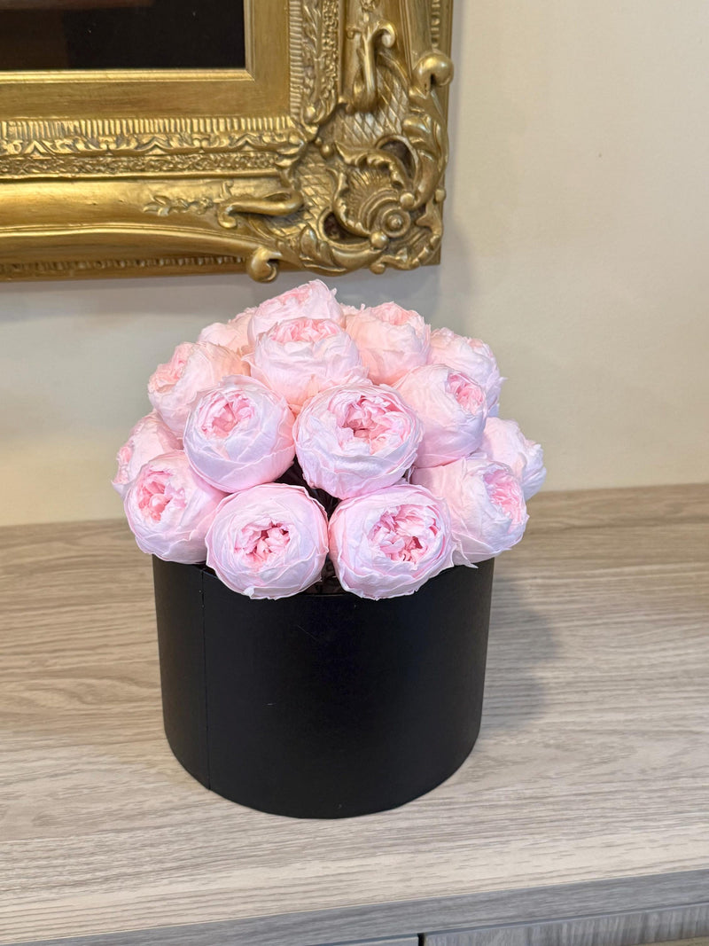 Black round gift box with preserved pink peonies