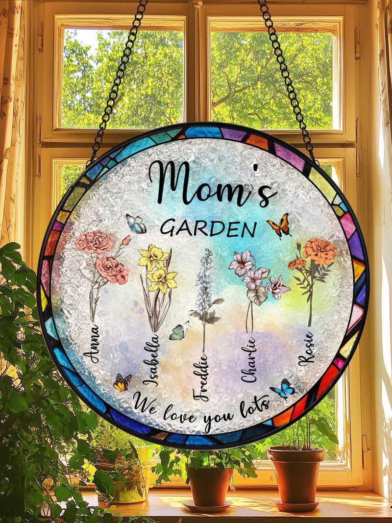 Round stained-glass suncatcher with blue frame, "Mom's Garden" and flower decals