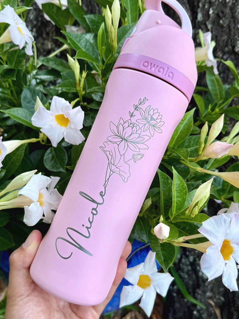Pink Owala tumbler with lid and floral line-art graphic on front