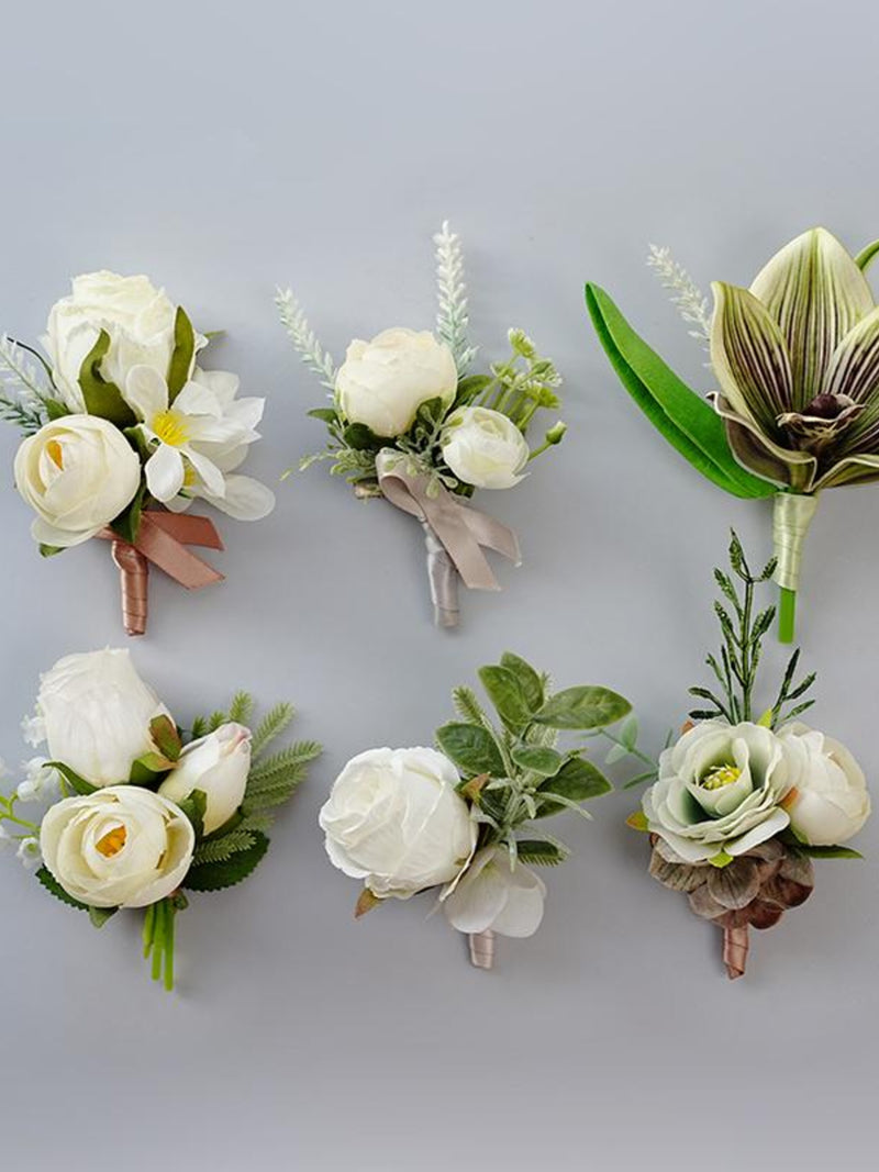 Ivory silk flower boutonniere set with green leaves and ribbon accents