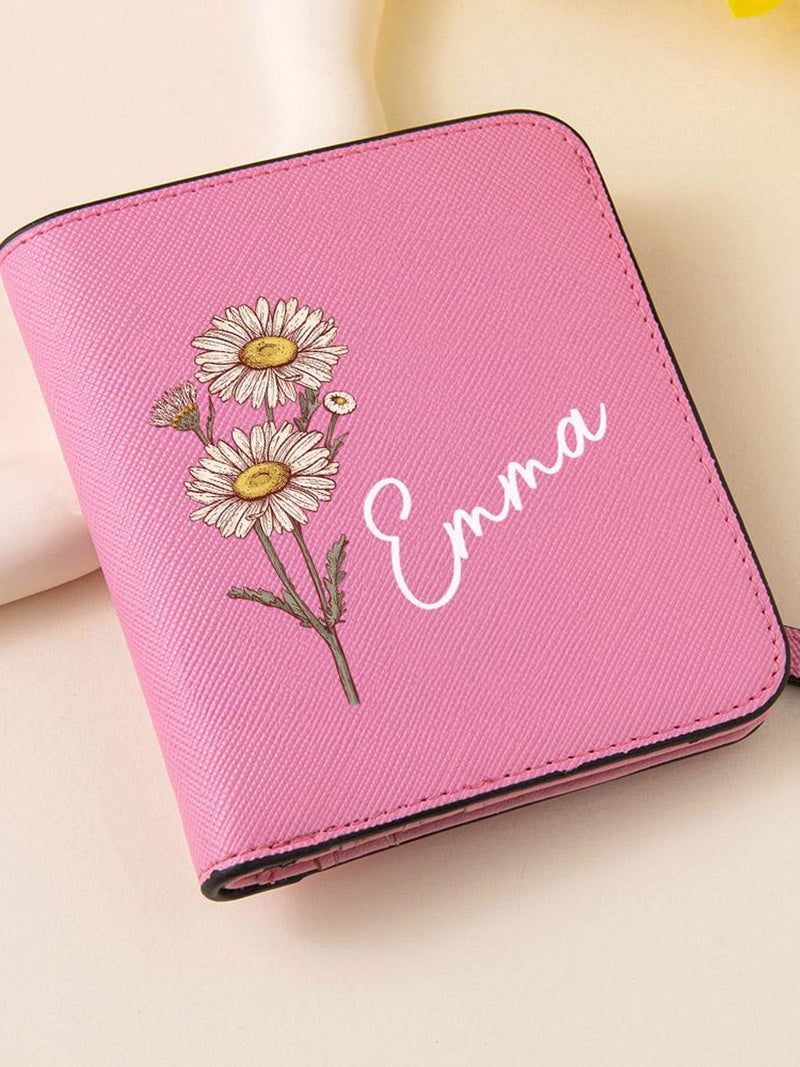 Pink wallet with daisy graphic and cursive name Uma