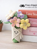 Plush floral bouquet with pastel fabric flowers and a small smiling bunny topper