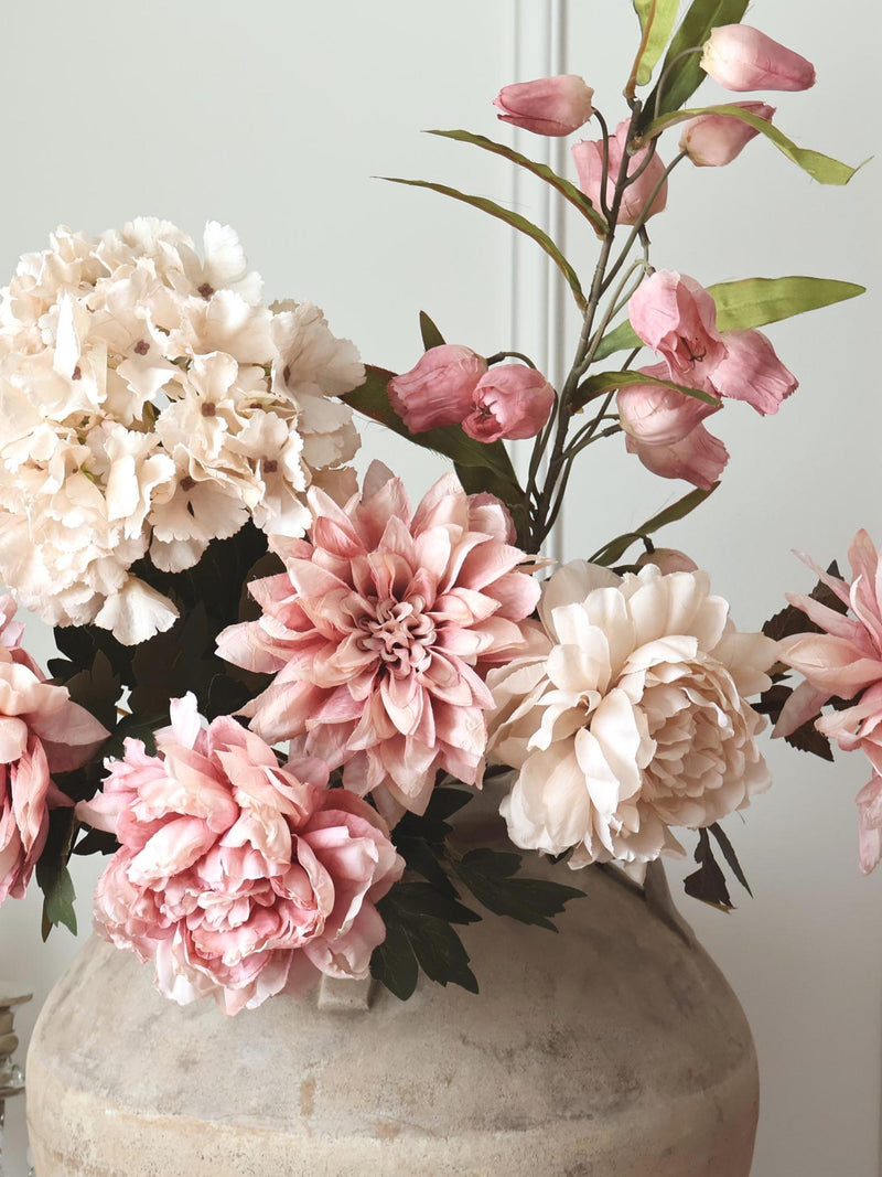 Pink and cream faux flower bouquet with peony, hydrangea-like blooms in a vase