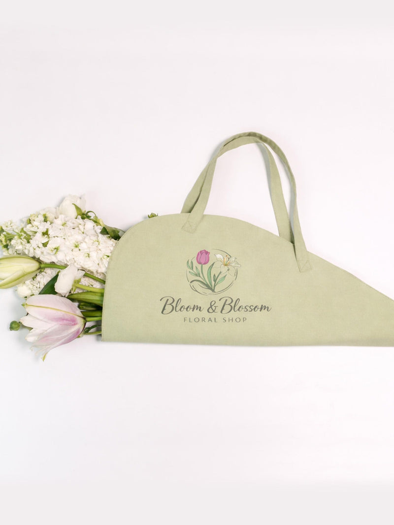 Sage green floral tote bag with printed shop logo and botanical graphic, open-top handles