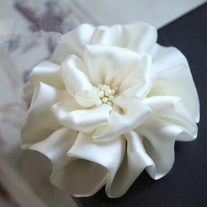 Handmade ivory silk fabric flower with layered petals and small center bloom