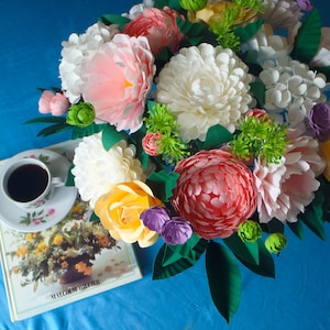 Colorful paper flower bouquet with 3D-style blooms and green leaves