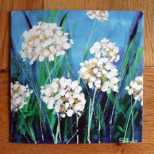 Large blank fine art greeting card with white flowers on blue and green background