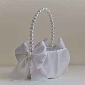 White flower girl basket with white bow and pearl handle