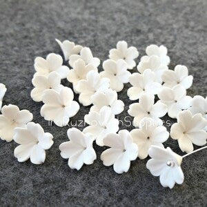 White five-petal polymer clay flower beads with pearl-like center dots