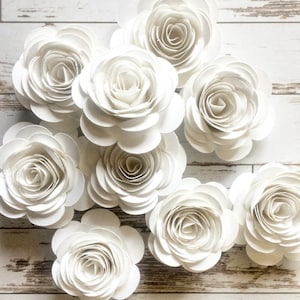 Rolled white paper flowers with layered petals, loose decorative bunch