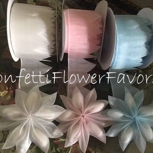 Set of paper pull bow ribbon flowers in white, pink, and blue, layered petals