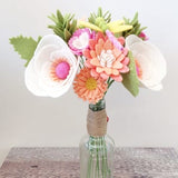 Felt flower bouquet with pink, peach, and white blooms and green leaves