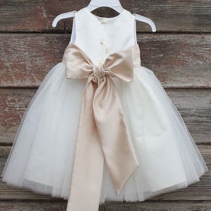 Flower girl dress with cream satin bow sash and white tulle skirt