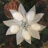White fabric flower hair clip with rhinestone center