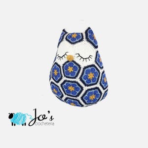 Blue crochet owl with African flower hexagon motifs, closed eyes and star accents