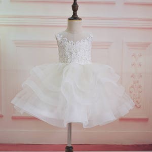 White lace bodice tulle flower girl dress with puff sleeves and layered skirt