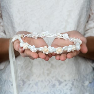 Ivory floral hair crown with small blossoms and pearl-like beads, braided headband