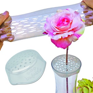 Flower frog stem holder with light blue base, holding a pink rose.