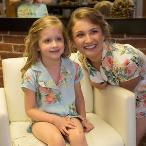 Children's floral short-sleeve pajama set with V-neck, worn by two girls