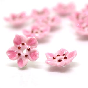 Pink glass flower (sakura) beads, 2 small blossom shapes with dark dot centers