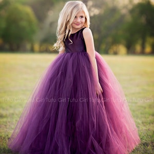 Purple sleeveless flower girl tulle dress with layered net skirt and bow at waist