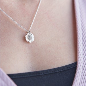 Silver sunflower pendant necklace with small flower charm on a fine chain