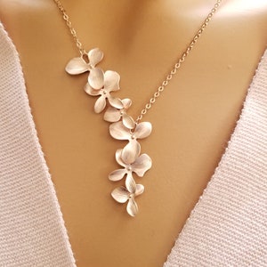 Rose gold orchid flower necklace with cascading five-petal pendant on chain