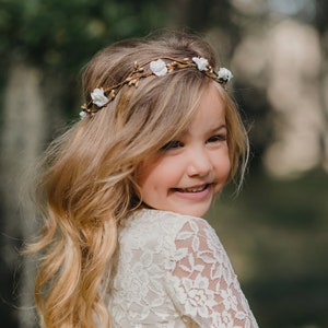 Child flower crown hair wreath with small gold and white blossoms on head
