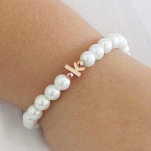 Children's pearl bead bracelet with rose gold lowercase initial k on stretch cord