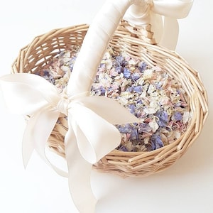 Flower girl basket with white satin bow and dried flower petals inside