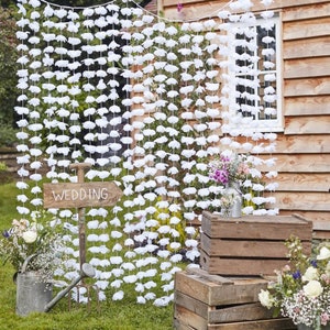 Hanging white floral garland curtain backdrop with layered flower strands