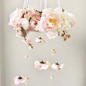 Pastel floral hanging mobile with pink and white flower clusters and small dangling pieces