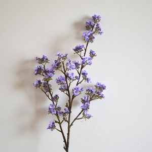 Silk small purple flower filler with branched stems and clusters of tiny blossoms