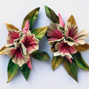 Leather flower brooch set with pink and cream petals and green leaf accents