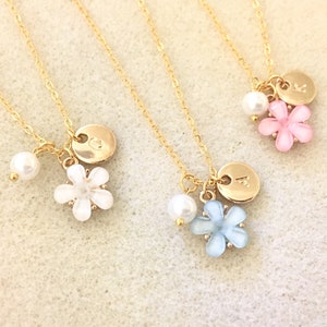 Gold-tone flower charm necklace with heart pendant and pearl bead drop