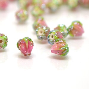 Pink flower glass beads with green leaves, small lampwork, drilled holes